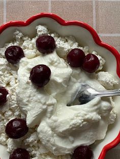 a bowl filled with ice cream and cherries