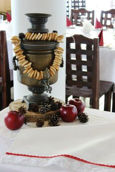 a table topped with an ornate vase filled with fruit