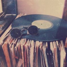 an old record player with sunglasses on top of records