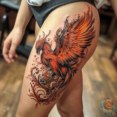 a woman's thigh with an orange bird on it