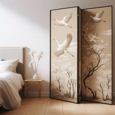 a room divider with two birds flying over the trees and flowers on it, in front of a bed