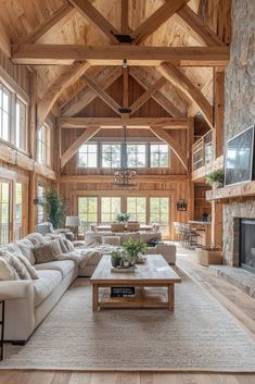 a living room filled with furniture and a fire place in the middle of an open floor plan