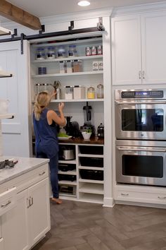 a woman standing in front of an oven