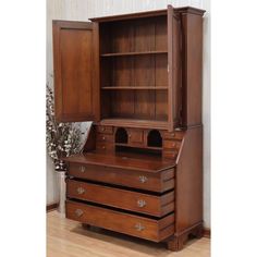 an old fashioned wooden dresser with drawers