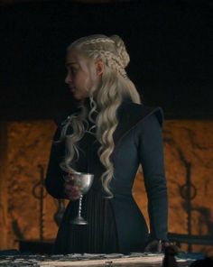 game of thrones'daeneress starke is holding a silver cup