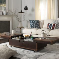 a living room filled with furniture and a fire place in front of a white wall