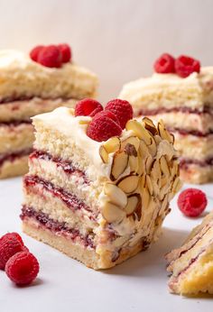 raspberry and almond layer cake cut in half with one slice missing from it