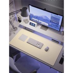 a computer monitor sitting on top of a desk next to a keyboard and mouse pad