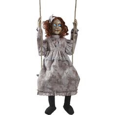 a creepy doll is on a swing with her hands in the air and eyes closed