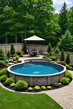 an outdoor pool surrounded by landscaping and greenery in the middle of a backyard area