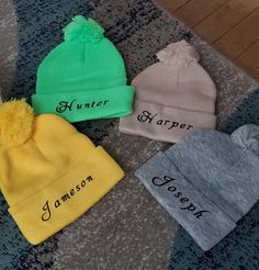 three beanies with name written on them sitting on the floor next to each other