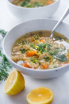 two bowls of soup with lemons and herbs