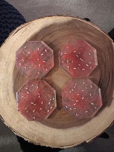 four pieces of wax sitting on top of a piece of wood