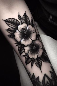 a black and white flower tattoo on the arm