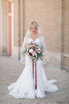 a woman in a wedding dress holding a bouquet