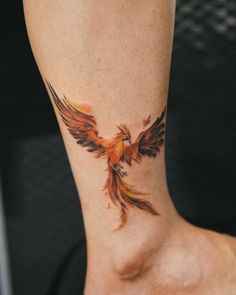 a woman with a tattoo on her ankle has a bird design on it's leg