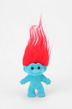 a blue troll doll with red hair on white background