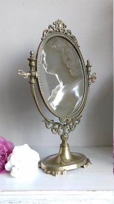 an antique vanity mirror with a woman's face in it