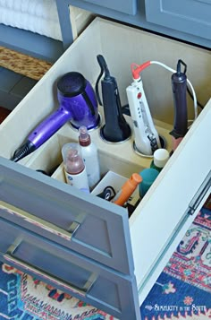 an open drawer with hair products in it