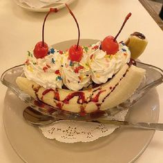 a banana split with whipped cream, cherries and sprinkles on top