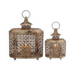 two metal lanterns sitting next to each other