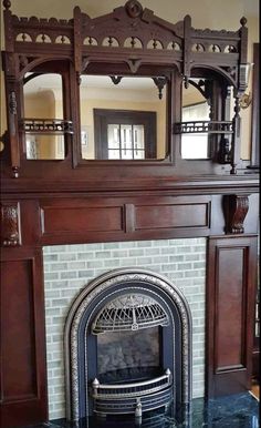 a fireplace with a mirror on top of it