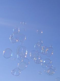 soap bubbles floating in the air on a sunny day