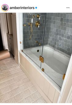 a bathroom with a tub and tiled floor