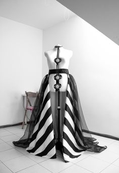 Absolutely stunning black and white taffeta overskirt with tulle layer on top and lace trim. Stripes are all handmade so if you want this gown in other color combinations or all skirt to be one color (no stripes) i will make it special for you! You can wear it over your dress, romper, jumpsuit, bodysuit, pants as you love it most. What you have to send when you place an order: 1 Waist round measurement 2 Straight line from waist to floor ( this is not skirt length ) 3 Color prefer 4 Phone number Black Organza Gown With Sheer Details, Black Wedding Dress With Voluminous Skirt, Elegant Skirt With Detachable Long Train, Organza Dress With Tulle Skirt And Long Train, Black Tulle Dress With Voluminous Skirt, Fitted Tulle Skirt With Long Train, Fitted Floor-length Organza Skirt, Black Couture Wedding Gown, Elegant Party Skirt With Detachable Train