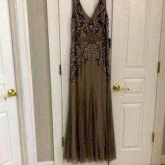 a dress hanging on the wall in front of two doors