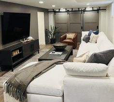 a living room filled with furniture and a flat screen tv