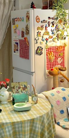 there is a table with food on it in front of a refrigerator and window sill