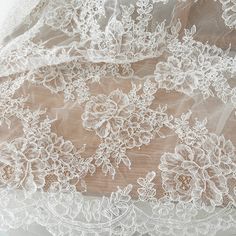 an image of white lace on fabric