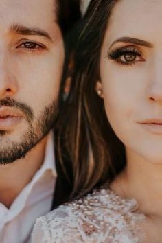 a man and woman are posing for a photo with their eyes close to the camera