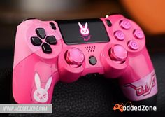 a pink video game controller sitting on top of a table