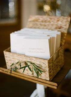 a wicker basket with business cards in it