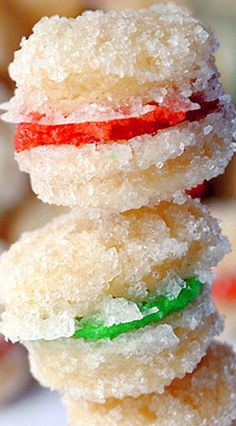 three sugar donuts stacked on top of each other with candy in between the doughnuts