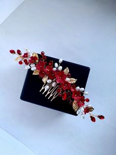 Enhance your hairstyle with this red hair comb adorned with handmade red flowers, perfect for adding a vibrant touch to any look. Measuring approximately 7.5 inches in width, this unique red hair accessory is ideal for brides or anyone seeking a bold red headpiece. This bridal hair comb is carefully handcrafted, making it a one-of-a-kind piece for weddings, events, or special occasions. Whether you're searching for red hair pieces or a standout bridal hair piece, this floral red headpiece will a Red And Gold Hair Accessories, Red Hair Piece, Red Headpiece, Red Hair Pieces, Red Hair Accessories, Hair Accessories Red, Bridal Hair Headpiece, Gold Hair Accessories, Headpiece Bridal