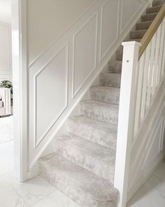 a white staircase leading up to a living room