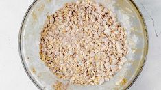 a bowl filled with oatmeal sitting on top of a white countertop