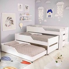 a child's bedroom with two white beds and a gray rug on the floor