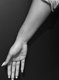 a woman's arm with a small tattoo on it, and the word love written in