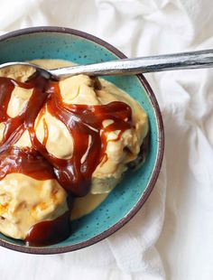 a bowl filled with ice cream and caramel sauce