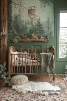 a baby's room decorated in green and white with deers on the wall