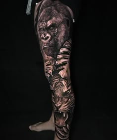 a man's leg with tattoos on it that has a gorilla and tiger on it