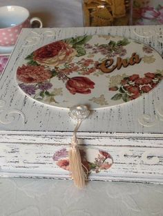 an ornate wooden box with flowers and the word ena on it is sitting on a table