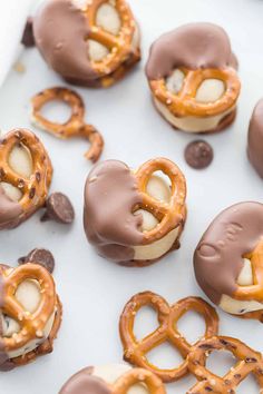 chocolate covered pretzels are arranged on a white plate with other pretzels