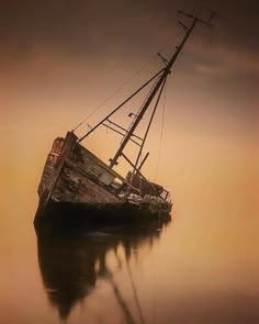 an old boat is sitting in the water