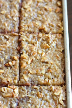 a pan filled with oatmeal squares sitting on top of a wooden table