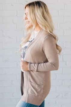 This perfect fit ribbed trim cardi has "take me for a latte" written all over it! Features a fitted sleeve, nice long length, POCKETS, and an open front. Super cozy and ready to be layered over your fave tops, and will keep you nice and warm all season long! 65% Cotton 35% Nylon Ribbed detail on sleeve cuff, pocket top and open front Soft, lightweight material SIZING: ﻿Model is 5'4" wears a size 5 and is modeling the size small. Small 0-4 Medium 6-8 Large 10-12 Neutral Soft Knit Cardigan For Fall, Fall Soft Knit Neutral Cardigan, Beige Winter Cardigan For Everyday Wear, Beige Winter Cardigan For Everyday, Everyday Winter Beige Cardigan, Long Sleeve Taupe Cardigan For Layering, Brown Stretch Outerwear For Layering, Cozy Everyday Cardigan, Taupe Fall Cardigan